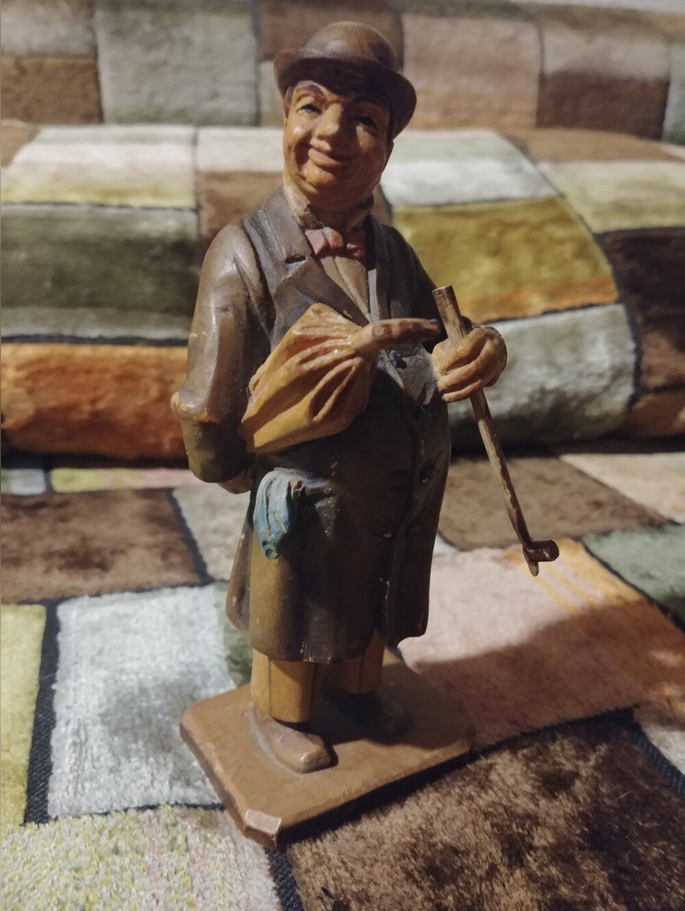 "Man with Umbrella & Pipe," which resembles pieces produced by ANRI